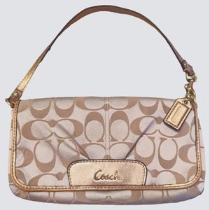 COACH WRISTLET CREAM AND GOLD WITH PINK INTERIOR
